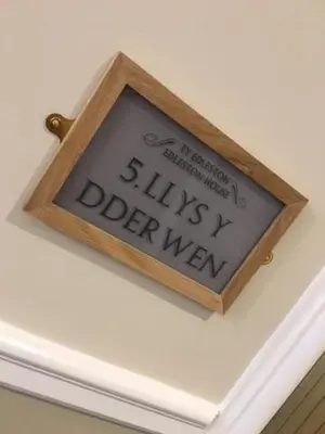 a sign that says slime olderward hanging on a ceiling at Llys y Dderwen - Oak Court in Aberystwyth