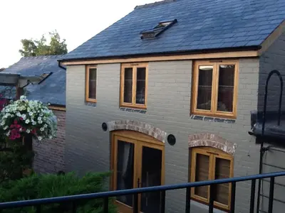a house with windows and a blue roof at The Queens in Ludlow