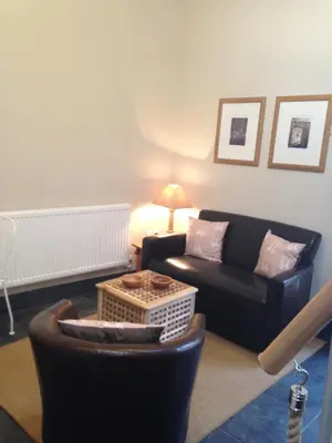 a living room with a couch and a table at The Queens in Ludlow