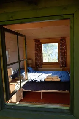 a small bedroom with a bed and a window at Log Cabin in Brecon