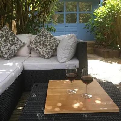 two glasses of red wine on a wooden table at Riverside Suites Llangollen in Llangollen