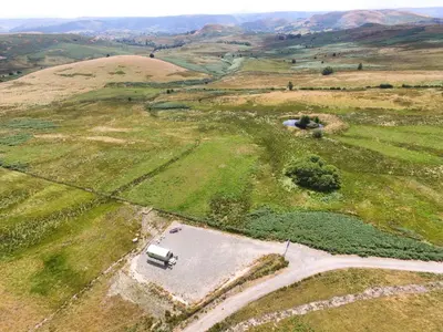 an aerial view of a truck on a road in a field at Upper Gilwern Quarry Hut in Llandrindod Wells