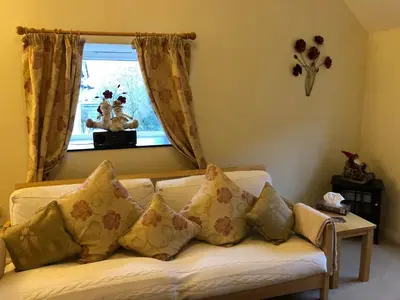 a living room with a couch with pillows and a window at Bryn Melyn Farm Cottages in Bala
