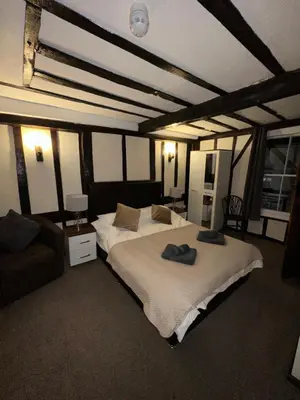 a bedroom with a large bed and a couch at 36 Heritage House in Kington