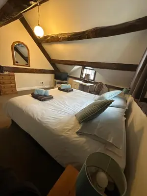 a bedroom with a large white bed with pillows at 36 Heritage House in Kington