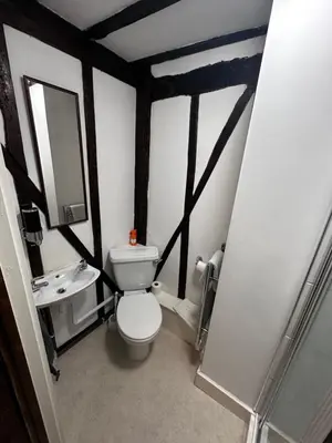 a small bathroom with a toilet and a sink at 36 Heritage House in Kington