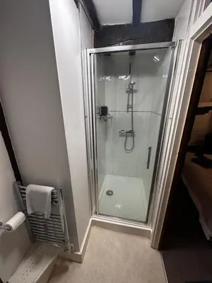 a shower with a glass door in a bathroom at 36 Heritage House in Kington