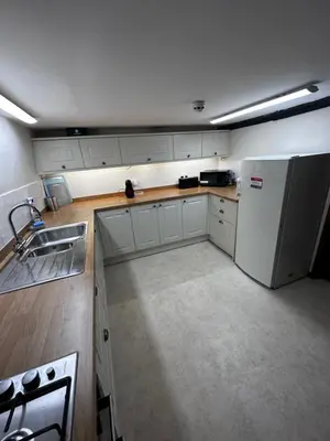 a kitchen with a white refrigerator and a sink at 36 Heritage House in Kington