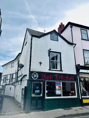 a white building with a sign that says that kitchen at 36 Heritage House in Kington