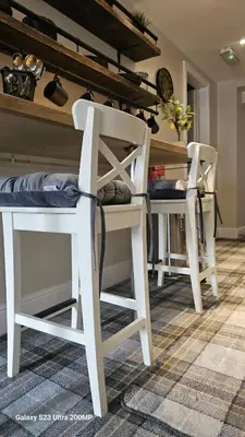 two white chairs and a table in a room at Bala Holiday Suites in Bala