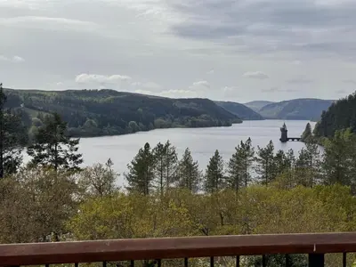 a view of a lake with a castle in the distance at Bala Holiday Suites in Bala