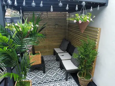 a patio with two chairs and potted plants at Bala Holiday Suites in Bala