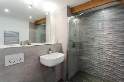 a bathroom with a sink and a shower at Owl Barn at Penygaer Great views of Brecon Beacons in Llandovery