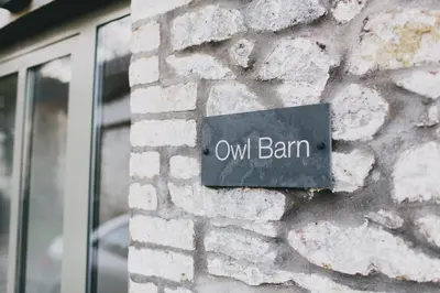a sign on a brick wall with the word owl barn at Owl Barn at Penygaer Great views of Brecon Beacons in Llandovery