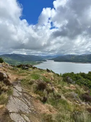 a view of a large body of water on a hill at Yr Hen Feudy in Barmouth