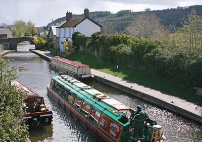 two boats in a river with people on them at The Gremlin Lodge in Brecon