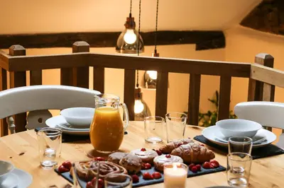 a wooden table with food and drinks on it at Lake Cottages at Cwm Chwefru in Llanafan-fawr