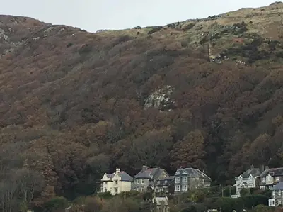 a group of houses in front of a mountain at Bluebells guest house in Barmouth