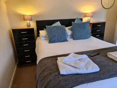 a bedroom with two beds with blue pillows at The Lamb and Flag Inn in Rhayader