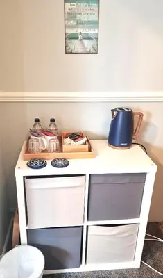 a white counter top with a blue lamp on it at Hafan Artro in Llanbedr