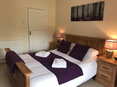 a bedroom with a bed with two towels on it at Hafan Artro in Llanbedr
