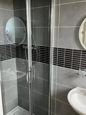 a bathroom with a shower and a sink at Sunray Suites in Barmouth