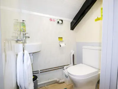 a bathroom with a toilet and a sink at Y Bwthyn in Tal-gareg