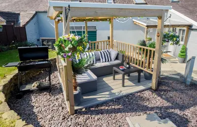 a porch with a couch and a gazebo at Y Bwthyn in Tal-gareg