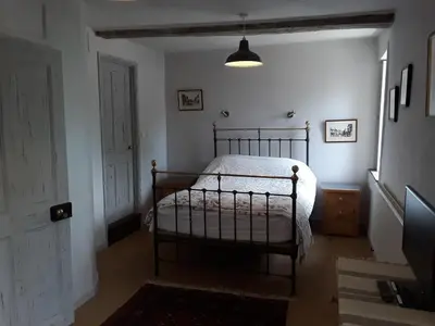 a bedroom with a bed in the corner of a room at 6 Bridge St. in Brecon
