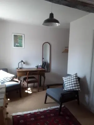 a living room with a table and chairs and a mirror at 6 Bridge St. in Brecon