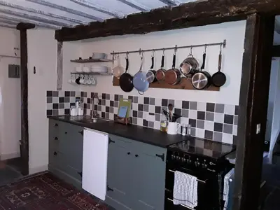 a kitchen with pots and pans hanging on the wall at 6 Bridge St. in Brecon