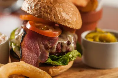 a close up of a sandwich with lettuce and tomato at The Castle Hotel in Llandovery