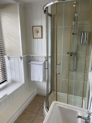 a bathroom with a shower and a sink at The Castle Hotel in Llandovery