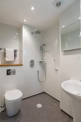 a bathroom with a shower and a toilet and a sink at Marine Studios in Aberystwyth