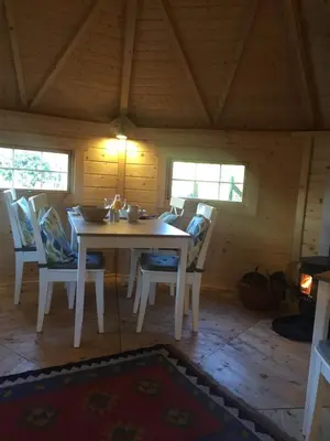 a dining room with a table and chairs in a cabin at Pandy B&B in Dorstone
