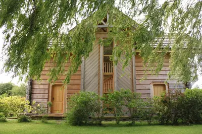 a wooden house with a bench in front of it at Pandy B&B in Dorstone