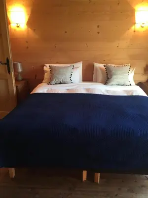 a bedroom with two beds with blue sheets at Pandy B&B in Dorstone