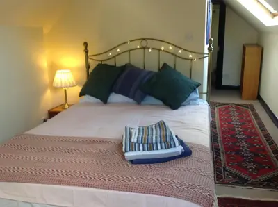 a bedroom with a large bed with two pillows on it at Maescelyn in Aberystwyth