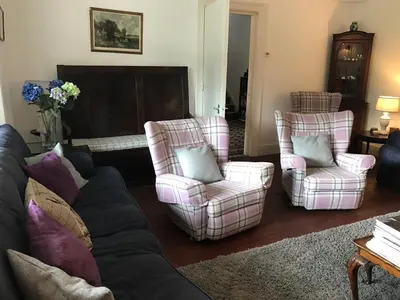 a living room with a couch and two chairs at Ty Mawr Hotel in Llanbedr