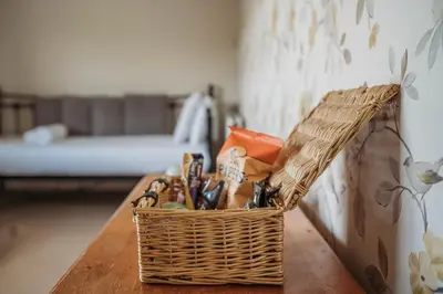 a basket of utensils sitting on a table at Three Wells B&B in Llandrindod Wells