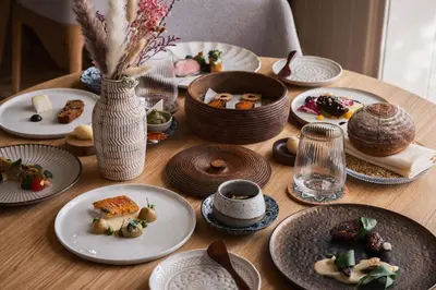 a wooden table with plates of food on it at Tyddyn Llan Restaurant with Rooms in Corwen