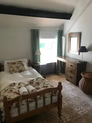 a bedroom with a bed and a window at Aberystwyth, Pentre Farmhouse, in Capel Bangor