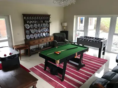 a living room with a ping pong table in it at Aberystwyth, Pentre Farmhouse, in Capel Bangor