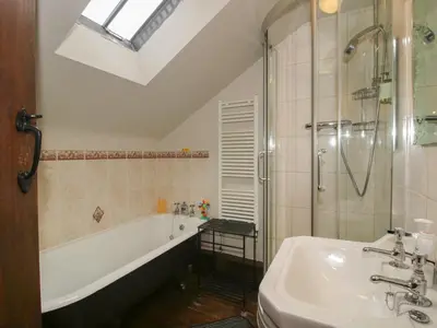 a bathroom with a tub and a sink and a shower at Corn House in Plaish