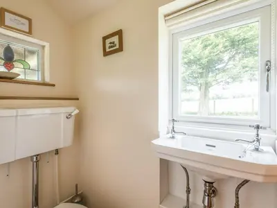 a bathroom with a sink and a window at Hillgate House in Bromlow