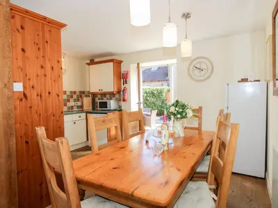 a kitchen and dining room with a wooden table at The Wain House in Acton Scott