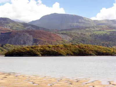 a large body of water with mountains in the background at Trem y Mor in Harlech