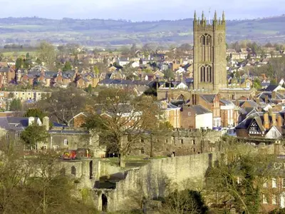 a city with a castle and a church at Manor Cottage in Ludlow