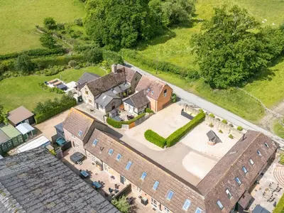 an overhead view of a large brick building at The Olde Cowshed in Acton Scott