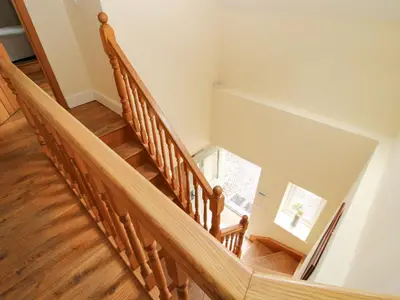 a staircase with wooden treads in a house at Old Coach House in Shrawardine